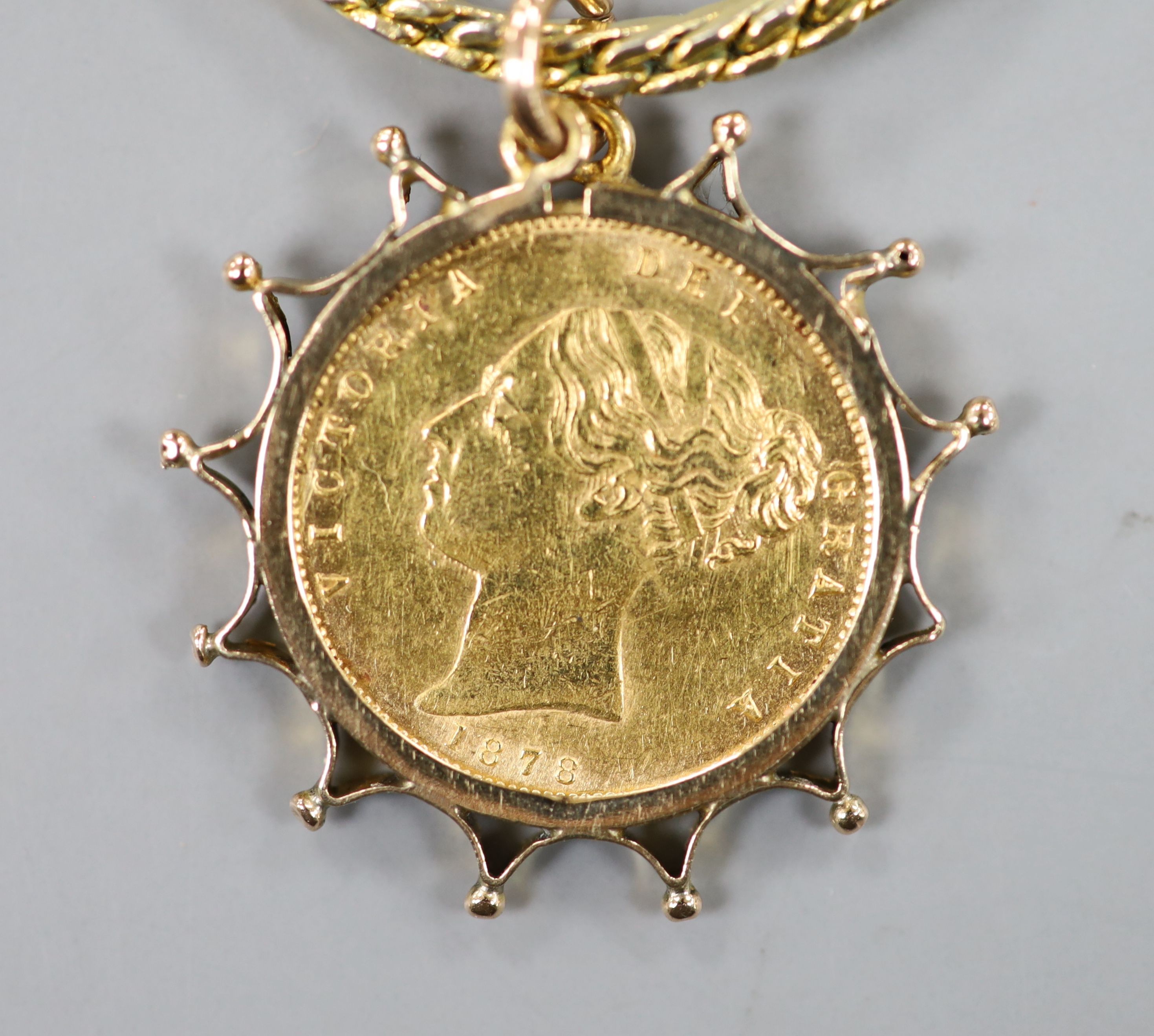 An 1878 gold half sovereign, in yellow metal pendant mount, on a gilt metal chain.